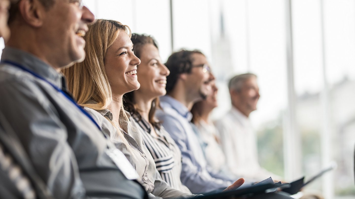 Happy business people in a line on a training class in the office.